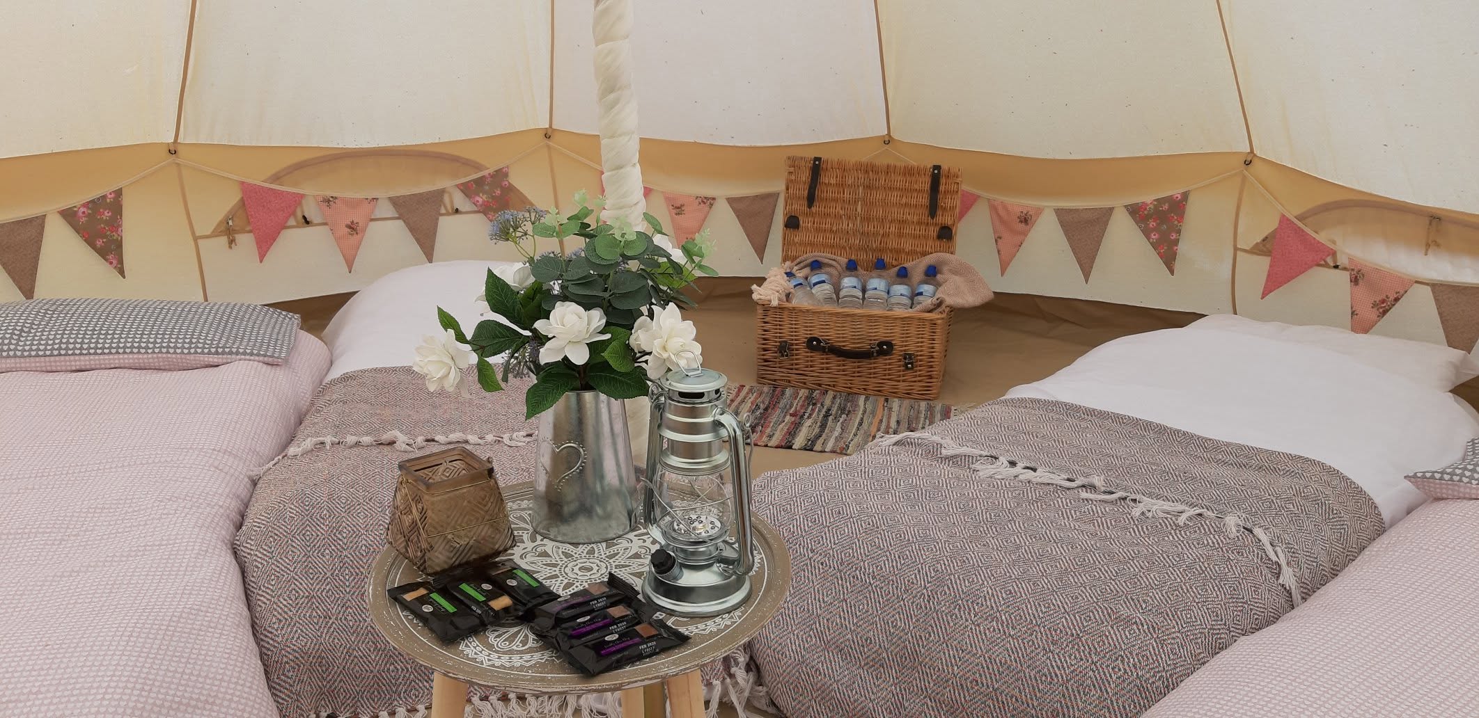 Furnished bell tent bedroom with bedside table
