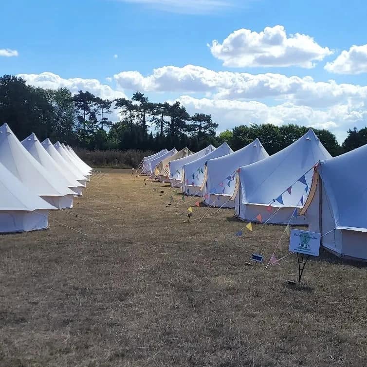 Bell tent village at an outdoor event